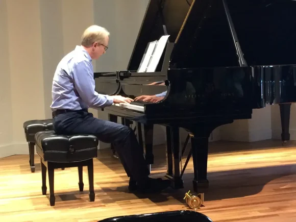 Vic Case playing piano at an adult recital